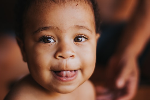 baby girl showing tongue